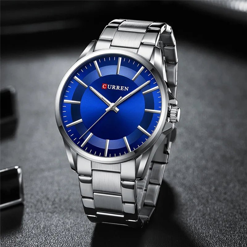Curren C9090G men's analog watch featuring a striking blue dial face and polished silver stainless steel link bracelet