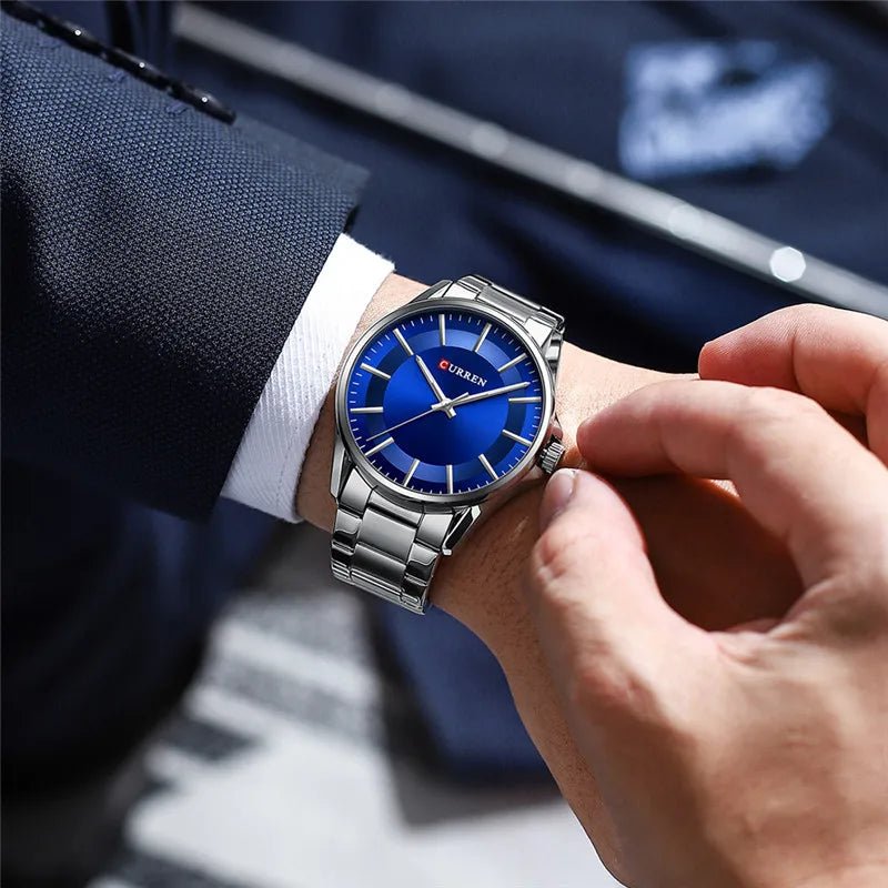Curren C9090G men's analog watch featuring a striking blue dial face and polished silver stainless steel link bracelet