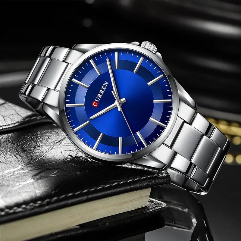 Curren C9090G men's analog watch featuring a striking blue dial face and polished silver stainless steel link bracelet