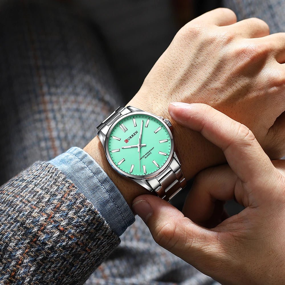 Curren C-9090G men's watch featuring a vibrant sea green analog dial and polished silver stainless steel link bracelet