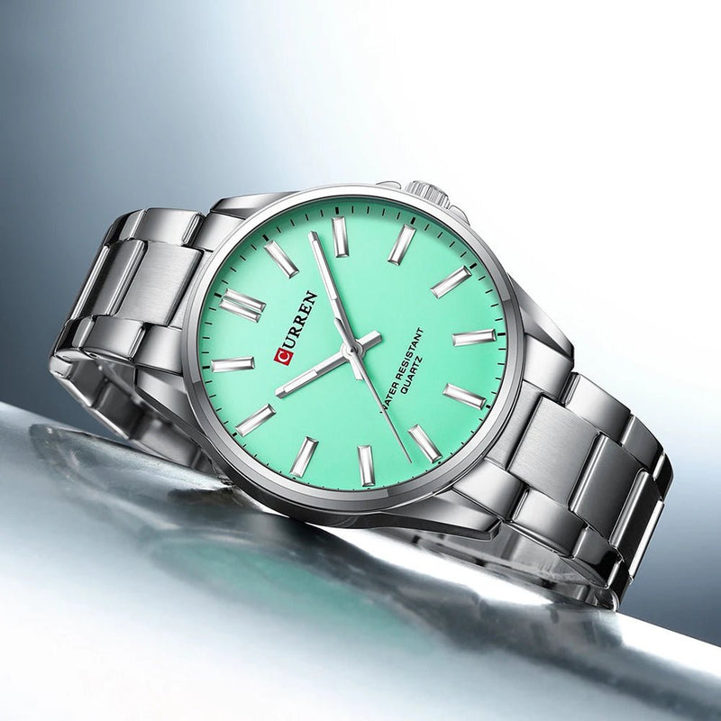 Curren C-9090G men's watch featuring a vibrant sea green analog dial and polished silver stainless steel link bracelet