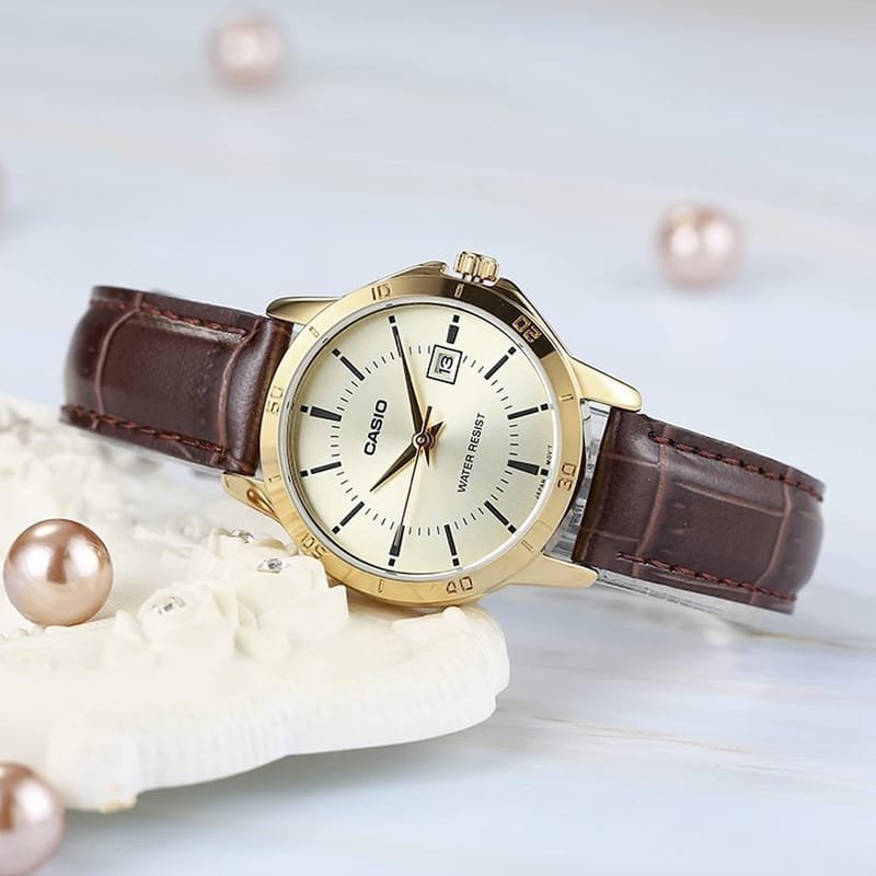 Casio LTP-V004GL-9AUDF quartz women's dress watch featuring a gold dial with date display and a genuine brown leather strap