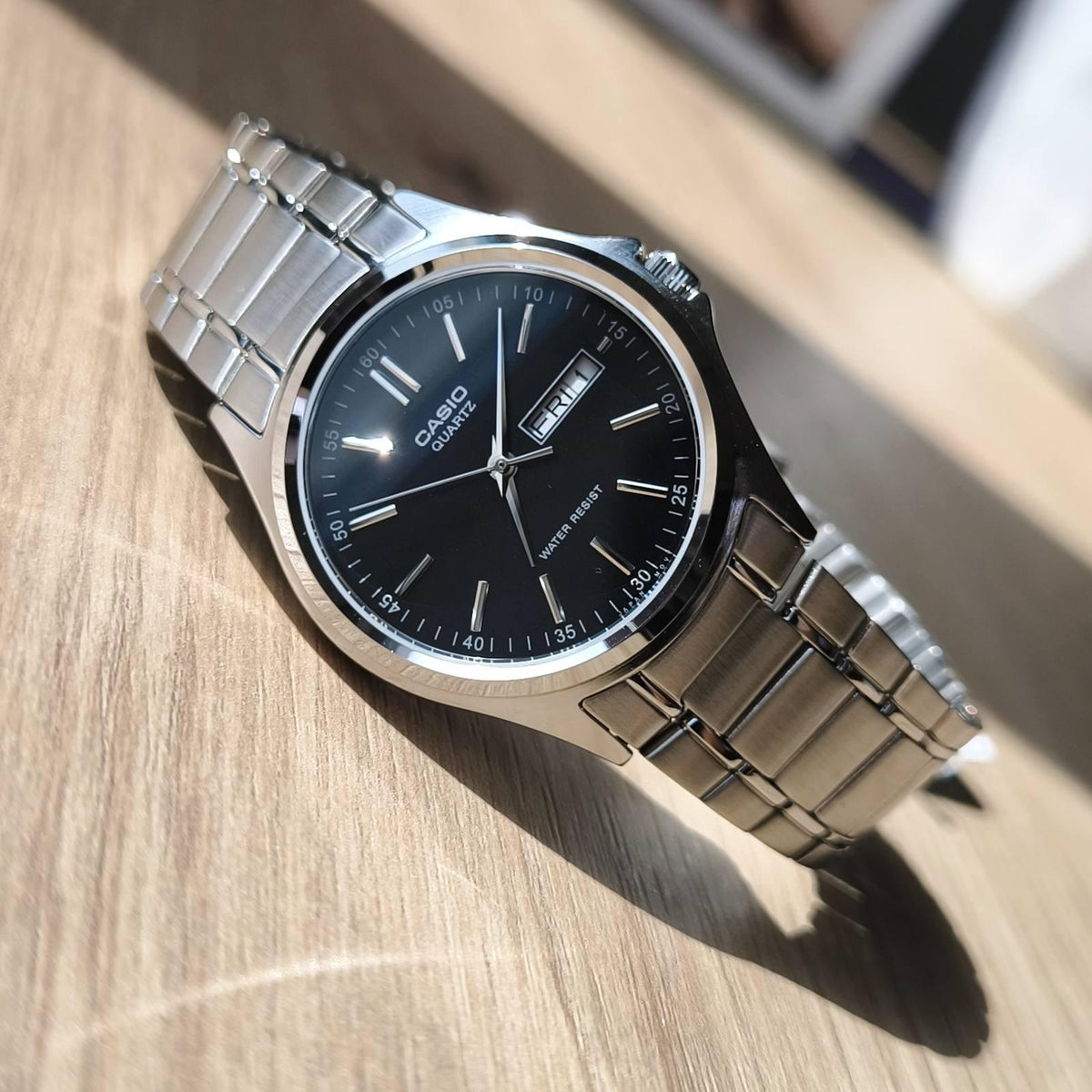 Casio MTP-1239D-1ADF men's watch featuring a sleek black analog dial and durable silver stainless steel bracelet