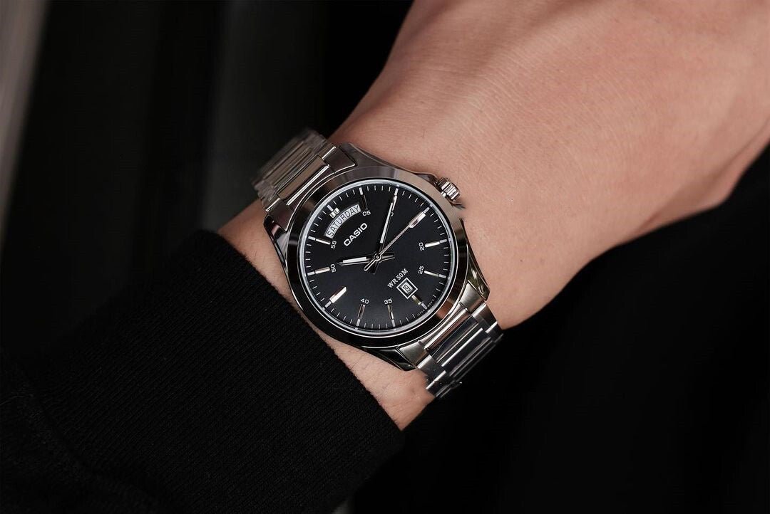Casio MTP-1370D-1A1VDF men's watch featuring a sleek black analog dial and polished stainless steel link bracelet