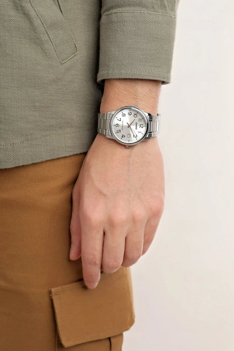 Casio MTP-V002D-7BUDF quartz men's dress watch featuring a silver dial with date display and polished stainless link bracelet